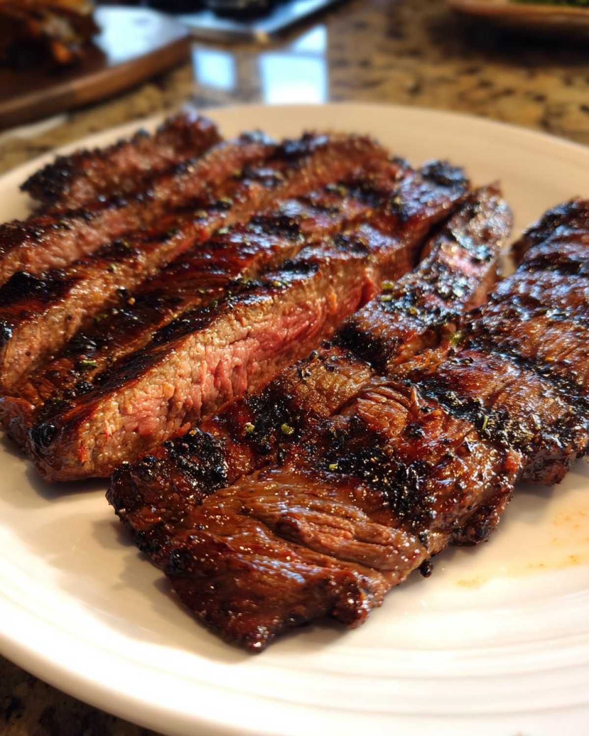 Close-up of sliced, juicy steak showing a medium-rare center, seasoned from the carne asada marinade.
