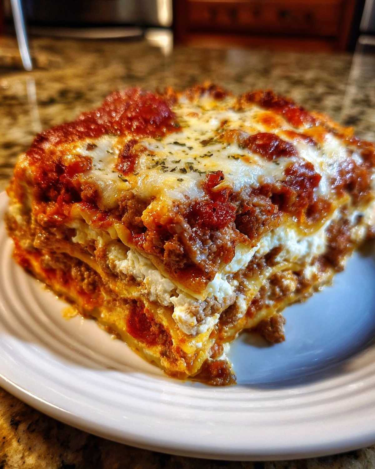 A thick, cheesy slice of Lasagna with Cottage Cheese layered with meat sauce and baked cheese topping.