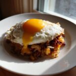 A serving of crispy Air Fryer Corned Beef Hash topped with a perfectly cooked sunny-side-up egg.