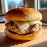 Close-up of a juicy Air Fryer Turkey Burger topped with melted white cheese on a toasted bun.