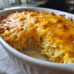Close-up of baked Copycat Cracker Barrel Hashbrown Casserole with melted cheddar cheese topping.