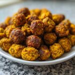 A white plate piled high with golden brown, seasoned Crunchy Air Fryer Ranch Chickpeas.