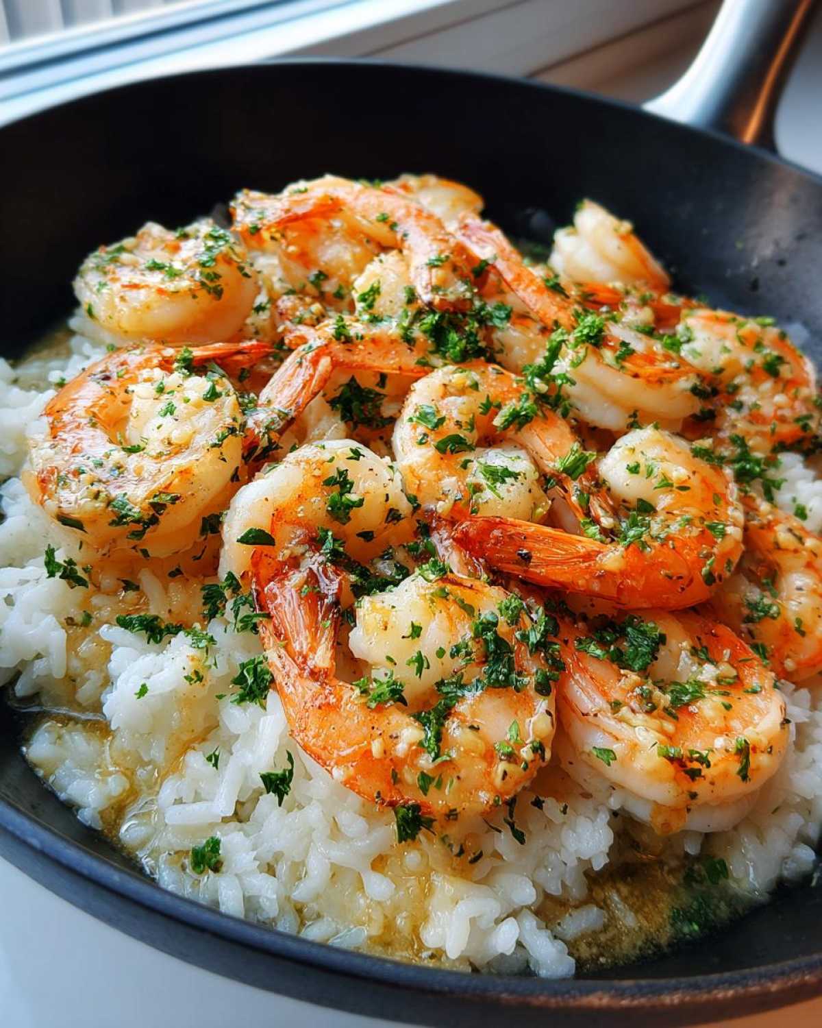 Close-up of Garlic Butter Shrimp and Rice Skillet, featuring plump shrimp in garlic butter sauce over white rice.