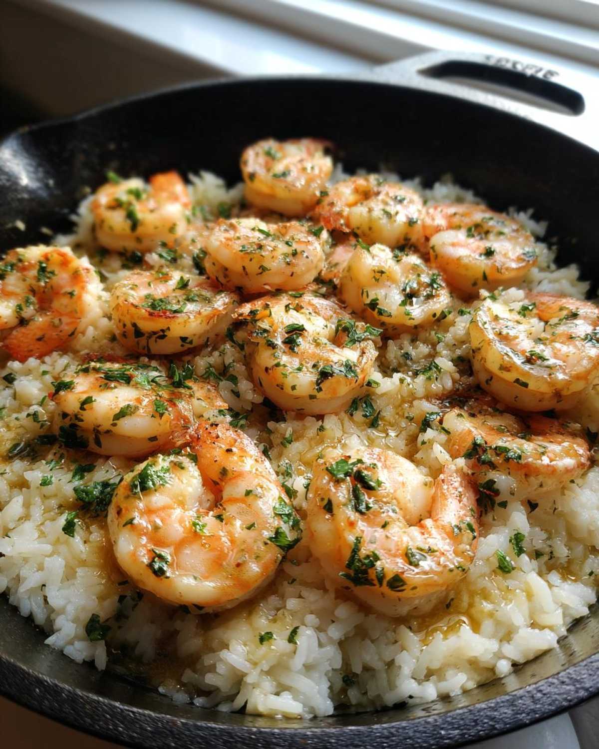 Close-up of Garlic Butter Shrimp and Rice Skillet, featuring plump shrimp in garlic butter sauce over white rice.