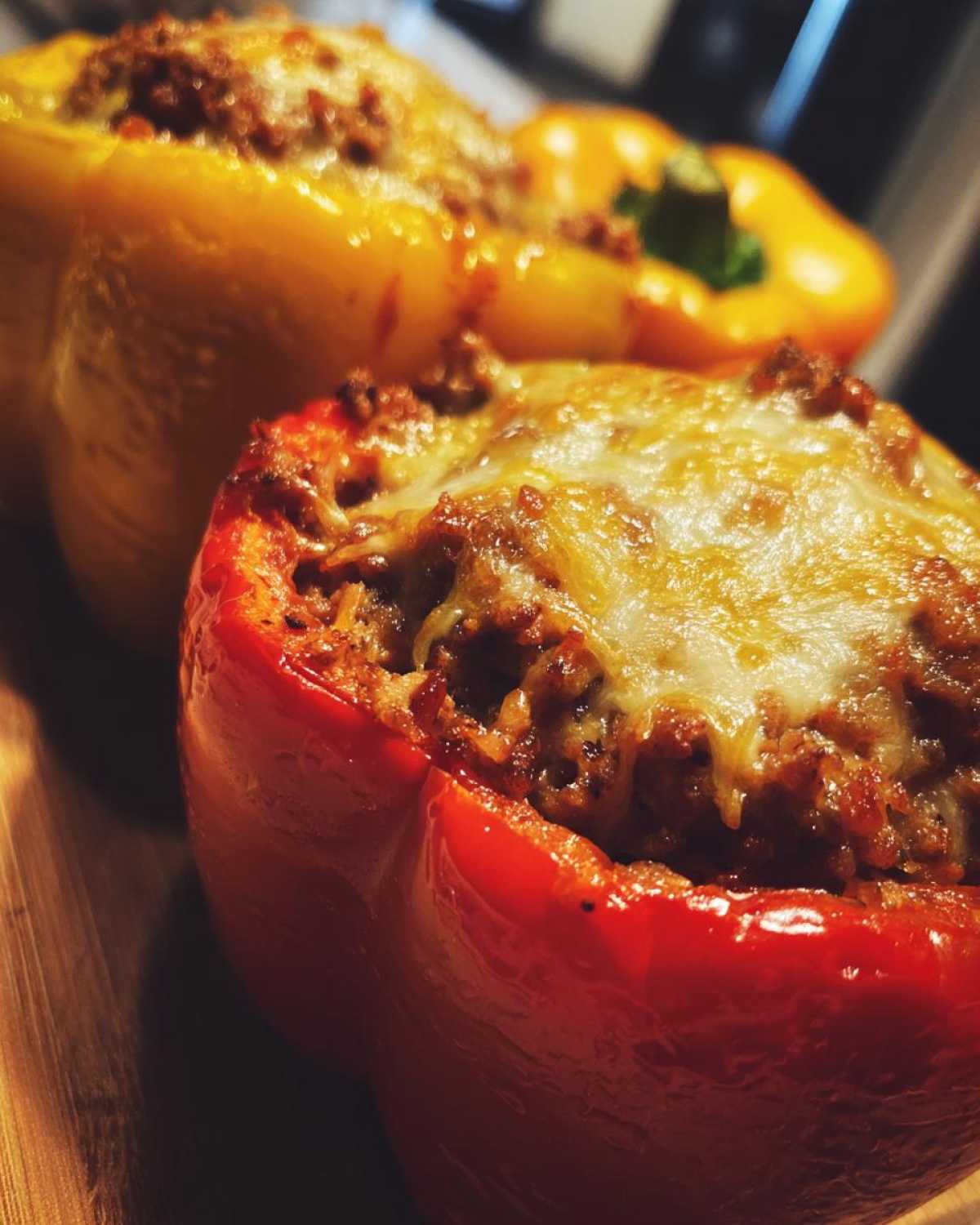Close-up of a red Keto Taco Stuffed Pepper filled with seasoned meat and topped with melted cheese.