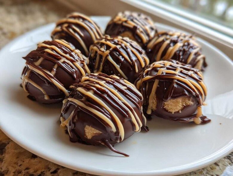 Close-up of several No-Bake Chocolate Covered Banana Bites drizzled with peanut butter on a white plate.
