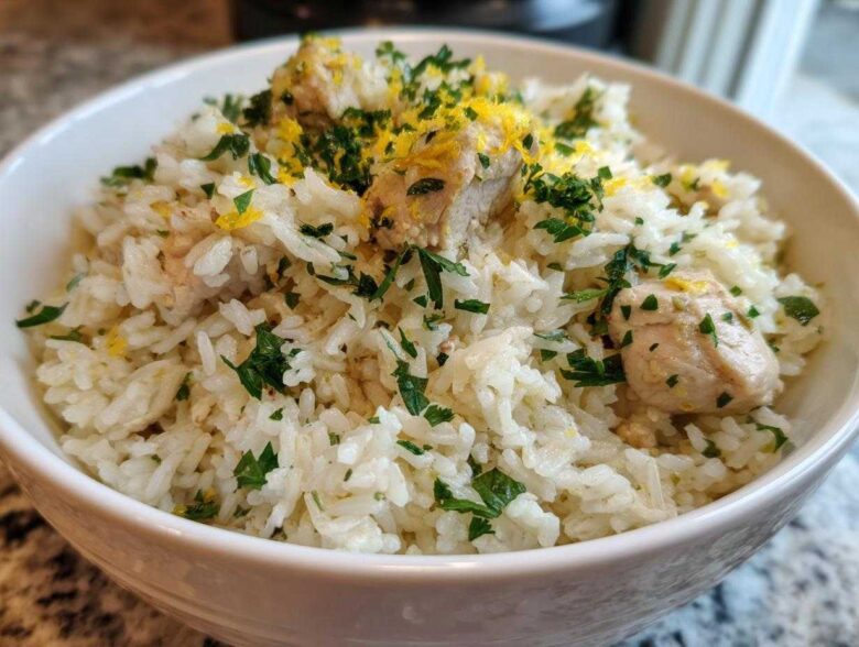 Close-up of One-Pot Chicken and Rice with Lemon and Herbs, topped with fresh parsley and lemon zest.
