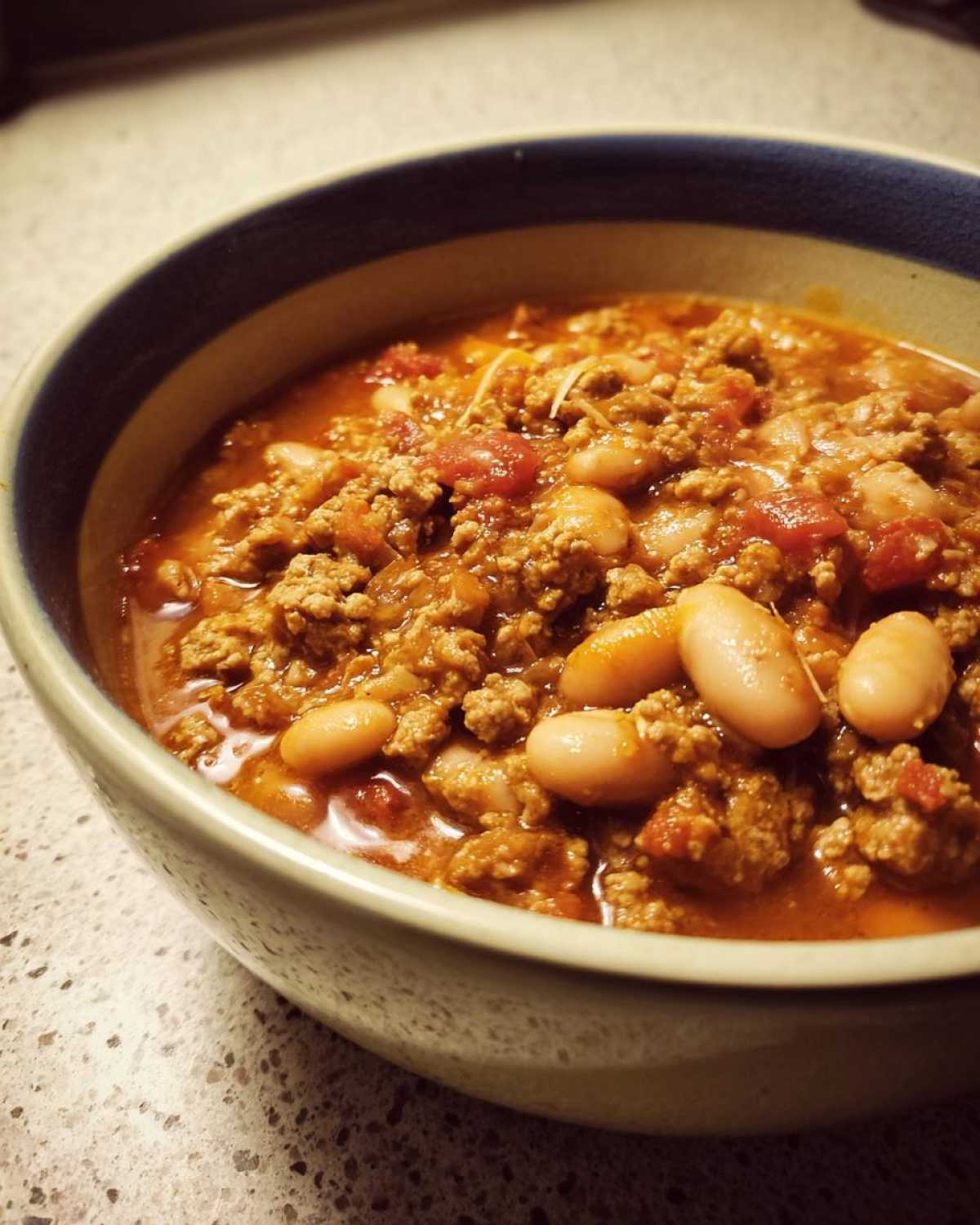 Close-up of a hearty bowl of Spicy Turkey White Bean Chili featuring ground turkey and white beans in a rich sauce.