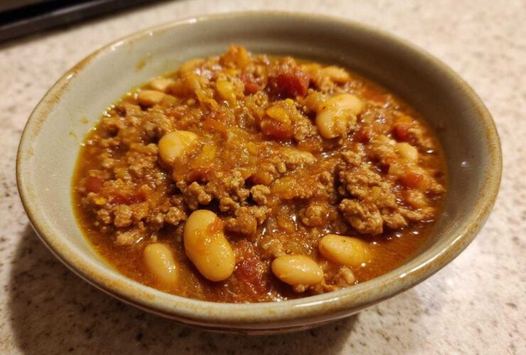 Close-up of a hearty bowl of Spicy Turkey White Bean Chili with ground turkey and large white beans.