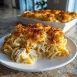 A generous serving of Cheesy Baked Chicken Alfredo with a golden, crispy breadcrumb top, served on a white plate.
