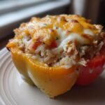 A single, baked Cheesy Chicken and Rice Stuffed Pepper, featuring melted golden cheese on top of a rice and chicken filling.