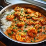 Close-up of Creamy Cajun Shrimp and Rice Skillet served directly in a stainless steel skillet, topped with parsley.