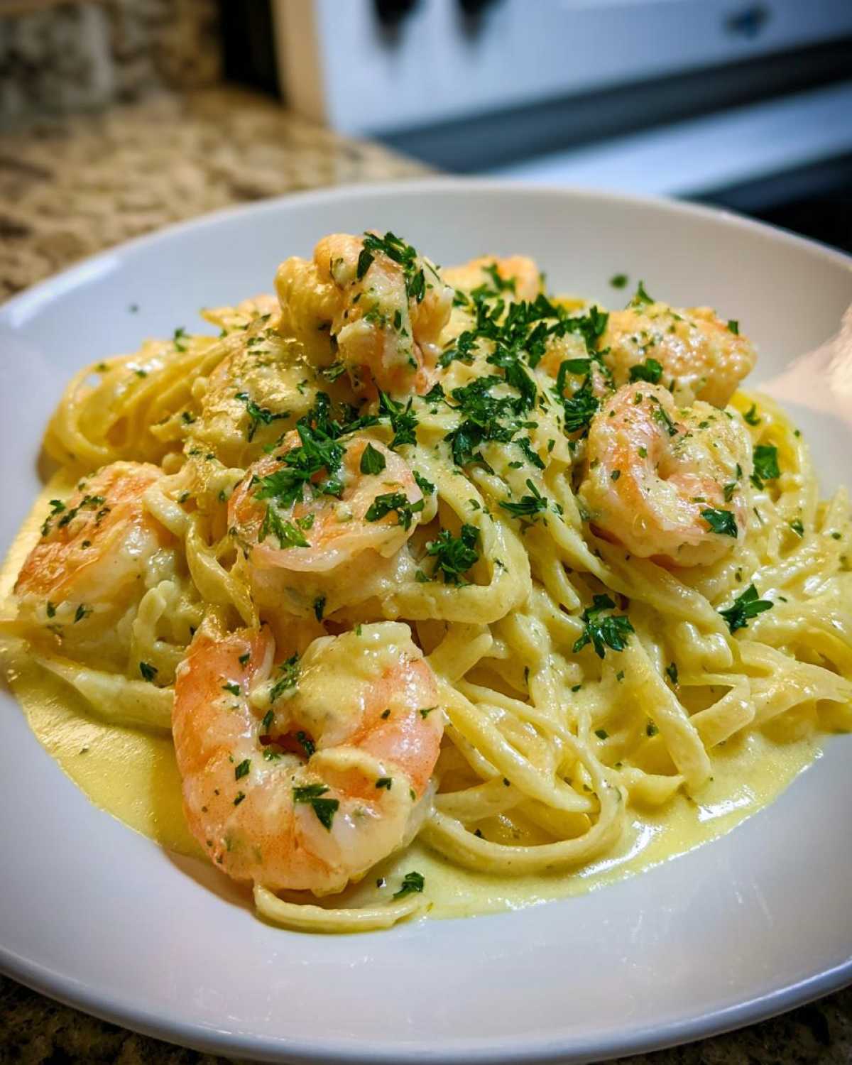 A close-up of rich Creamy Lemon Shrimp Pasta with Garlic Sauce, topped with fresh parsley.