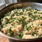 Close-up of Garlic Butter Rice with Chicken Skillet, featuring rice, chicken pieces, peas, and parsley.