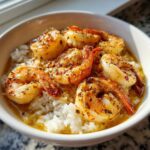 Close-up of a Garlic Butter Shrimp Bowl with Rice, featuring seasoned shrimp over white rice in a creamy sauce.
