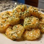 Plump shrimp coated in a rich Garlic Butter Shrimp with Creamy Parmesan Sauce, garnished with parsley.