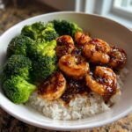 Close-up of a Honey Garlic Shrimp Bowl Quick Dinner featuring glazed shrimp over white rice and steamed broccoli florets.