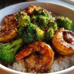 Close-up of a Honey Garlic Shrimp Bowl Quick Dinner featuring glazed shrimp and bright green broccoli over white rice.