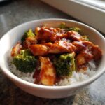 Close-up of a Honey Soy Chicken Bowl Quick Dinner Idea with glazed chicken pieces and bright green broccoli over white rice.