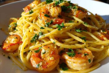 A close-up shot of Lemon Butter Shrimp Pasta tossed in a creamy sauce and garnished with fresh parsley.