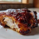 Close-up of a perfectly cooked Maple Dijon Chicken Thighs Recipe piece, showing the caramelized glaze and moist interior.