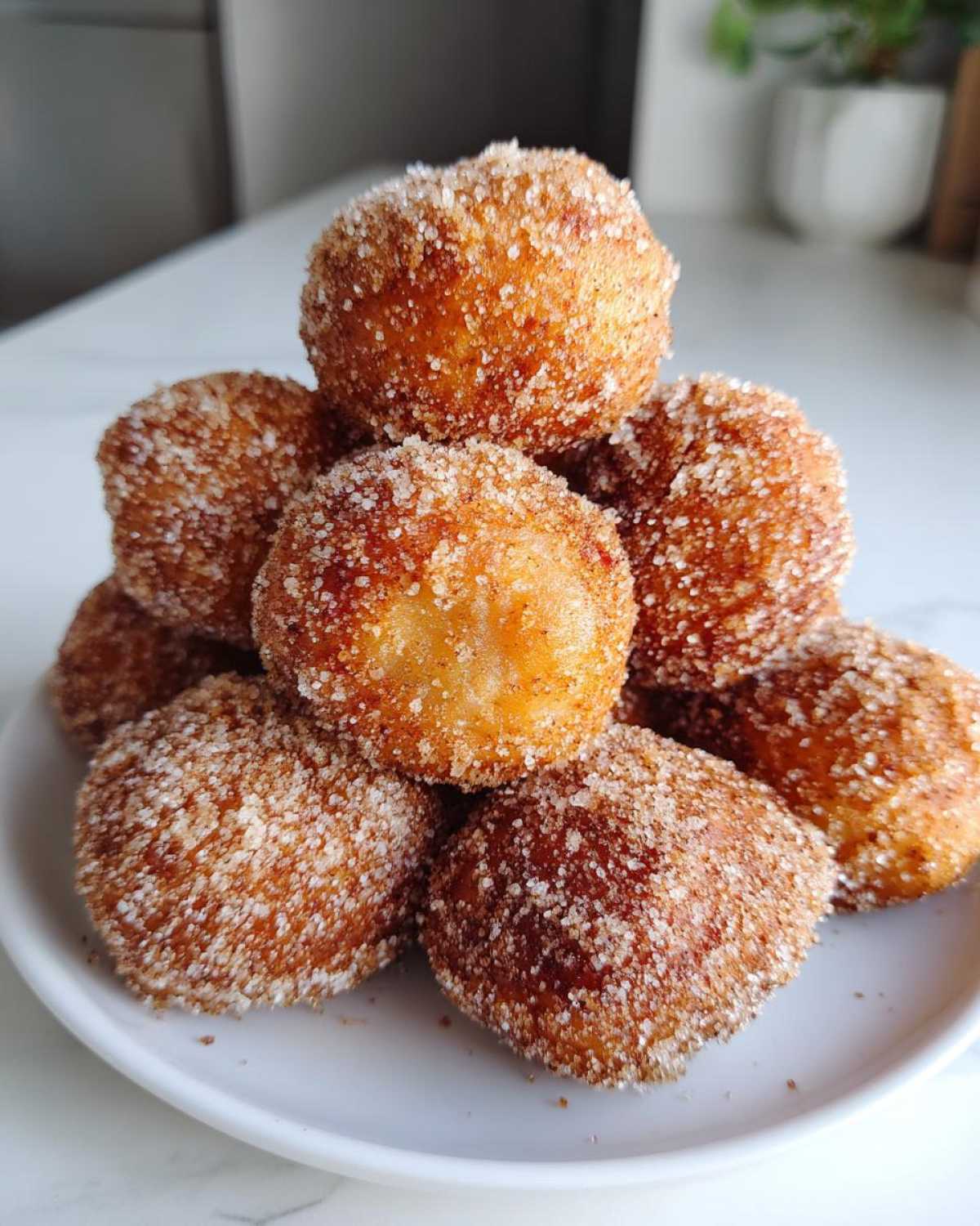 A stack of golden brown Soft & Sweet Cinnamon Sugar Biscuit Bites generously coated in sparkling cinnamon sugar.