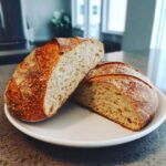 Close-up of Bakery Style French Bread cut in half, showing the open, airy crumb and crackly crust.