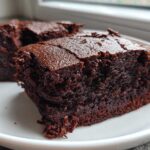 Two rich, dark squares of Easy Chewy Brownies Recipe Fudgy Brownies served on a white plate.