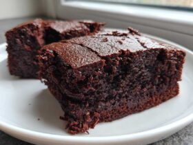 Two rich, dark squares of Easy Chewy Brownies Recipe Fudgy Brownies served on a white plate.