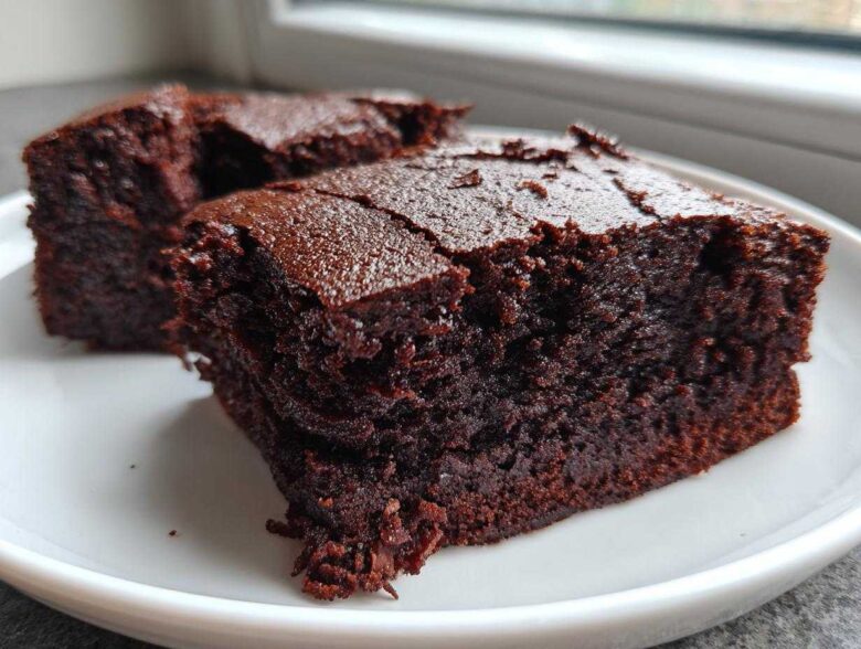 Two rich, dark squares of Easy Chewy Brownies Recipe Fudgy Brownies served on a white plate.