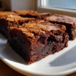A close-up of a rich, fudgy brownie square showing its chewy texture and crackly top from the Easy Chewy Brownies Recipe.