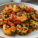 Close-up of succulent Garlic Butter Sauteed Shrimp coated in herbs and chili flakes, served in a white bowl.