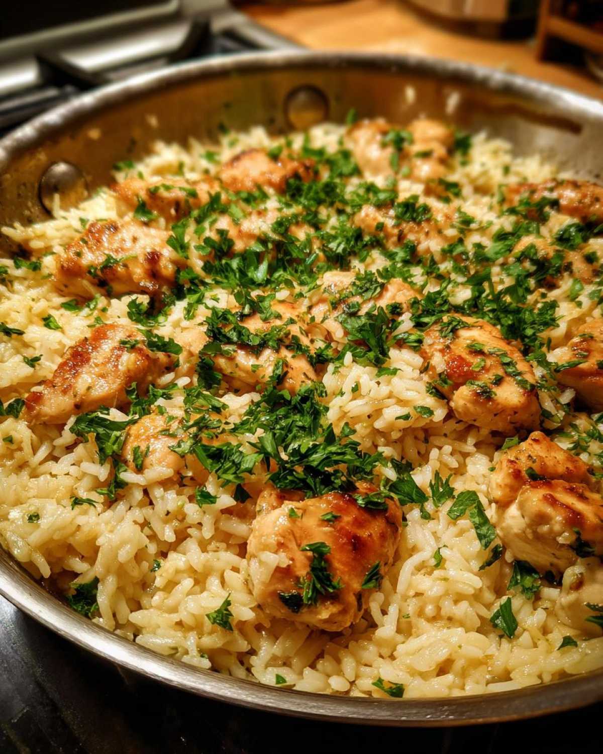 Close-up of the finished OnePan Garlic Butter Chicken Rice Skillet topped with fresh parsley.