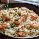 Close-up of Quick One-Pan Garlic Shrimp and Rice Recipe cooked in a skillet, topped with fresh parsley.