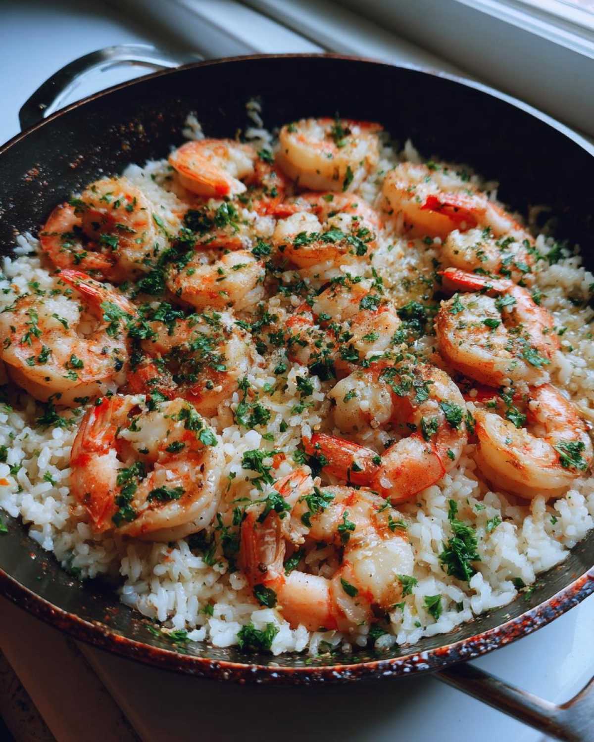 Close-up of Quick One-Pan Garlic Shrimp and Rice Recipe, topped with fresh parsley.