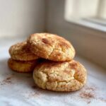 A small stack of four soft, chewy Snickerdoodle Cookies dusted generously with cinnamon sugar.