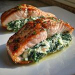 Close-up of a perfectly seared Spinach Stuffed Salmon fillet, split open to show creamy spinach filling.